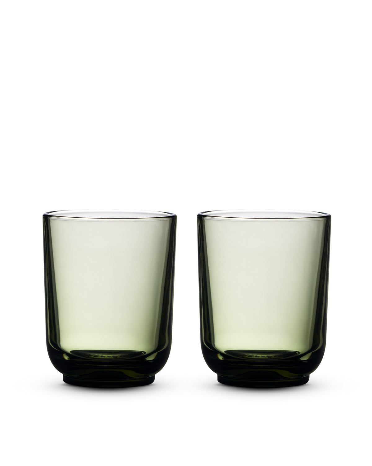 Two green Pirch Espresso Glasses by Fellow with rounded bases on a white background.