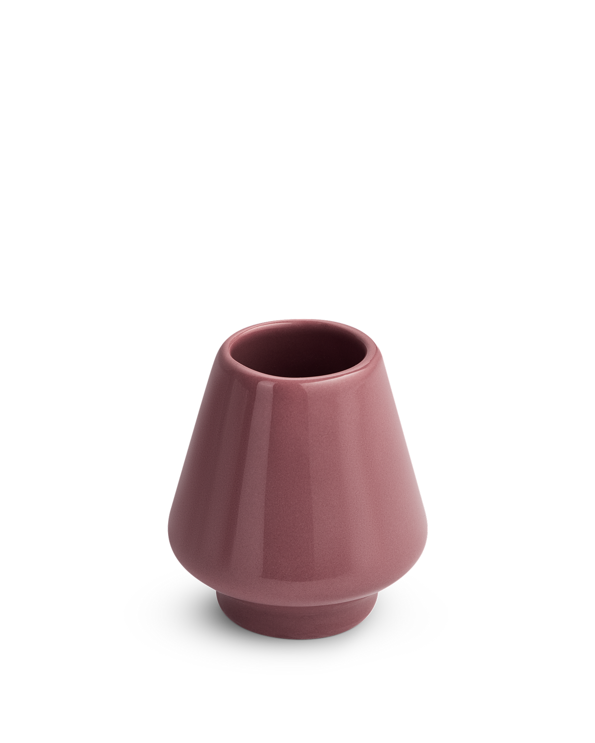 A small, glossy Desert Rose Matcha Set Whisk Holder by Fellow with a wide base and narrow opening.