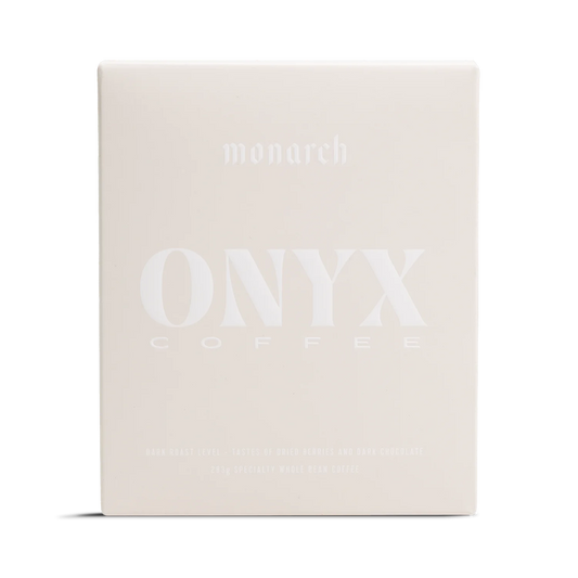 A light beige box labeled Monarch by Onyx Coffee Lab with a rich coffee design.