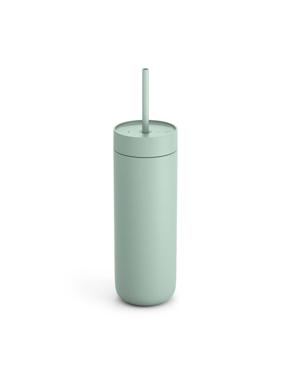 The Fellow Carter Cold Tumbler in matte light green with a straw on a white background.