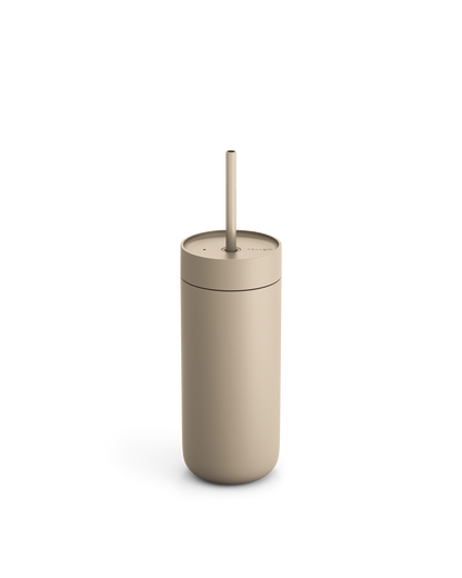Fellow Carter Cold Tumbler in beige with lid and straw shown on a white background.