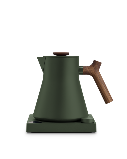 Fellow Corvo EKG Electric Kettle in matte green with wooden handle on a matching base.