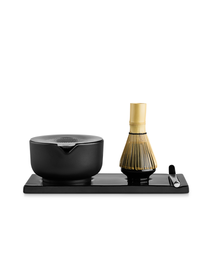 Fellow Matcha Set: ceramic bowl, bamboo whisk & spoon on black tray against white.