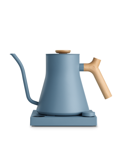 The Fellow Stagg EKG Electric Kettle: modern blue, wood handle, heats quickly, matching base.