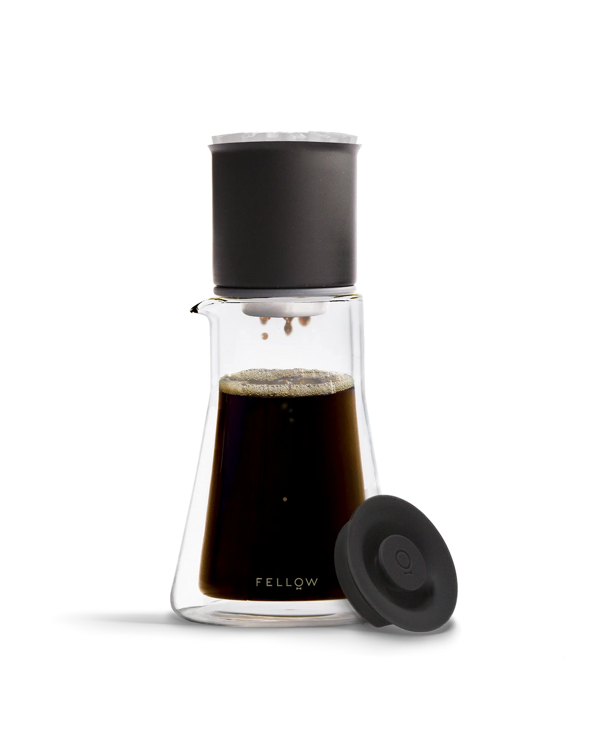 Fellow Stagg [XF] Pour-Over Set with black filter, lid, and coffee in the carafe.